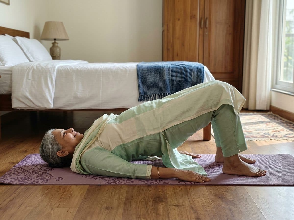 Glute bridge: an older Indian adult demonstrating the exercise at home
