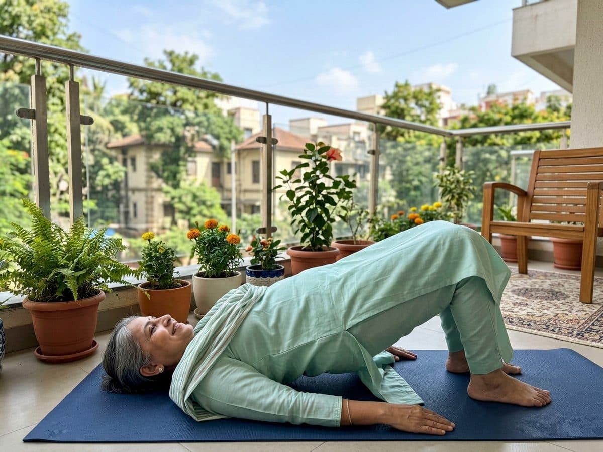 Glute bridge: an older Indian adult demonstrating the exercise at home